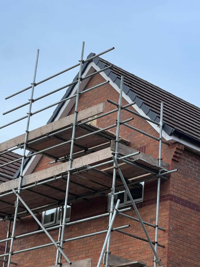 This is a photo of a roof which has just been repaired. There is a scaffold located at the gable end for access onto the roof. Works carried out by MCM Roofing Repairs Fordingbridge